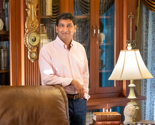 Owner of Rajkamal Palace in his elegant private library, a prestigious setting for Hyderabad weddings.